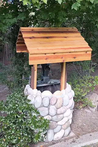Custom carpentry water well cover